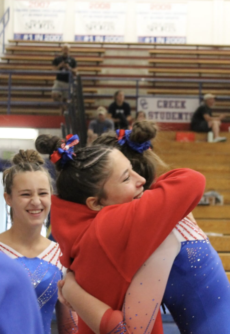 Bruins teammates celebrating with a hug in the stands
