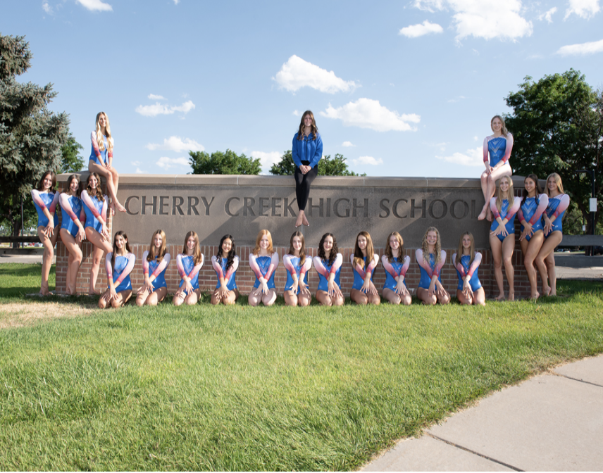 Cherry Creek Bruins gymnastics team posed at the Cherry Creek High School sign